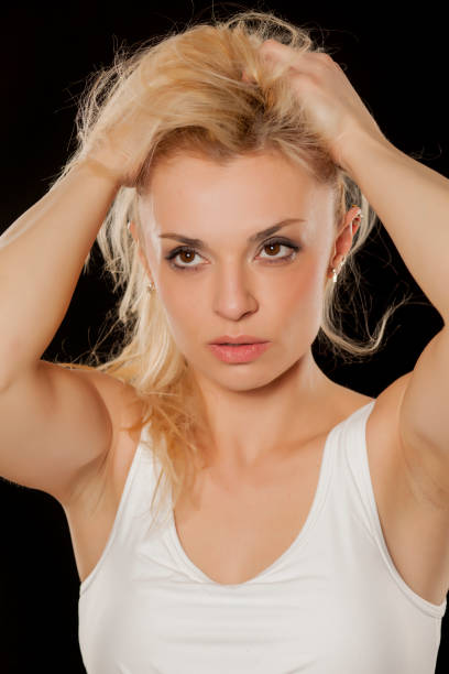 istock Beautiful sporty blonde posing on a black background 937276150