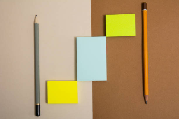 istock Three multi-colored sticky sticky paper and two pencils 937282176