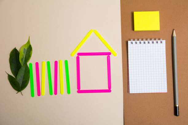istock House of counting sticks and a notebook with a pencil 937282234