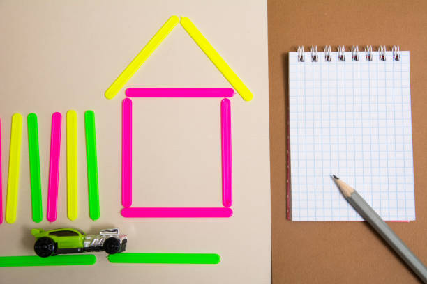 istock House of counting machine sticks and a notebook with a pencil 937282242