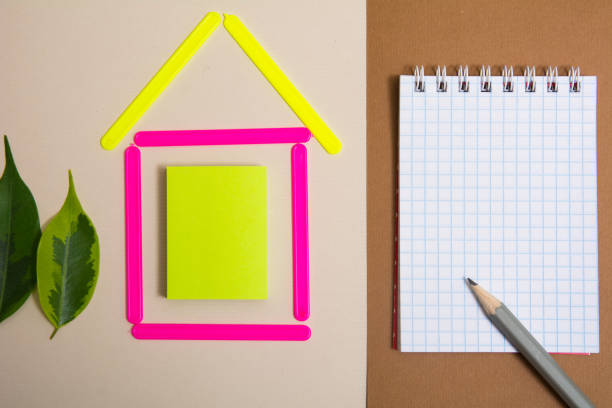 istock House of counting sticks and a notebook with a pencil 937282262