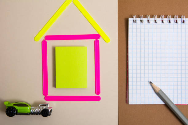 House of counting machine sticks and a notebook with a pencil