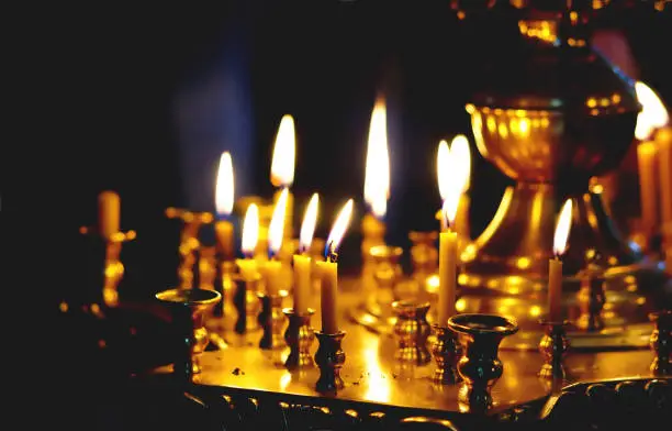 Burning candles in the church as a sign of repentance and mercy before God