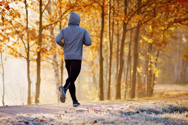 istock Young man running in the park during autumn morning 937283040