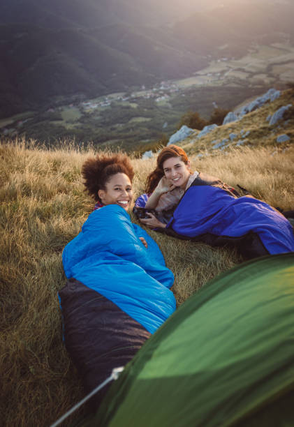 istock Two Young Women Camping on Top of Hill 937285440
