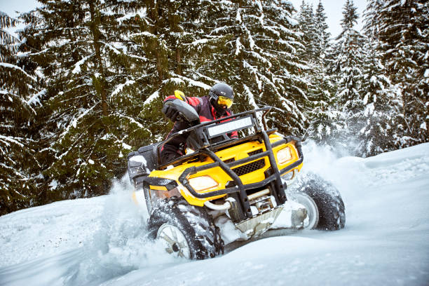 istock Winter race on an ATV on snow in the forest. 937285884