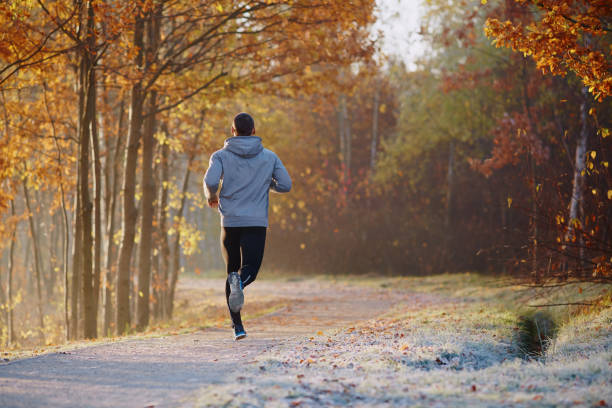 istock Young man running at park during autumn morning 937286532