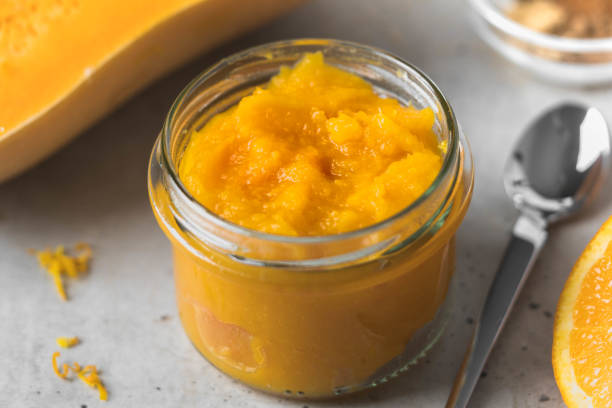 istock Pumpkin puree in a jar next to a spoon 937286738