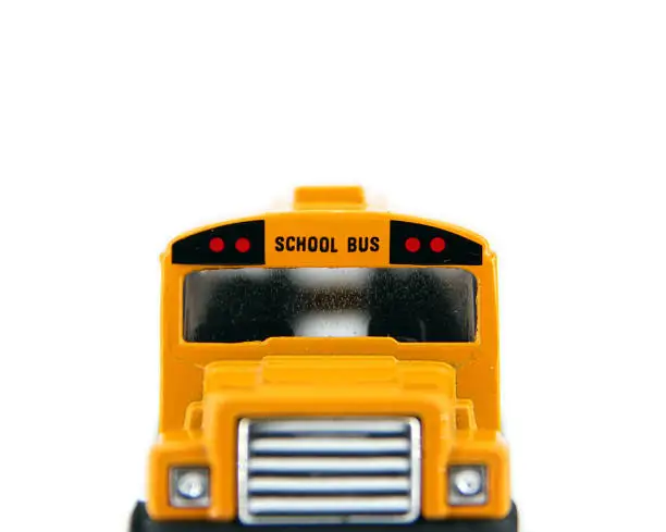 Front of toy, yellow school bus with frosted windows.
