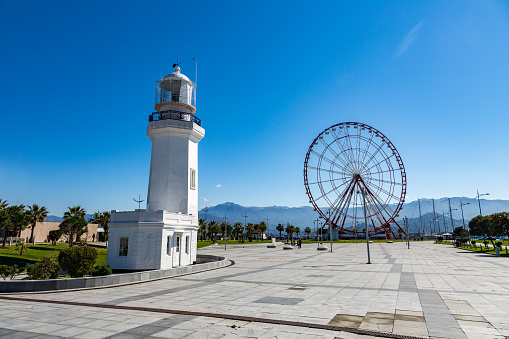 BATUMI, GEORGIA - MARCH 17, 2018: A snow-white lighthouse on the waterfront in Wonder Park. Built in 1863