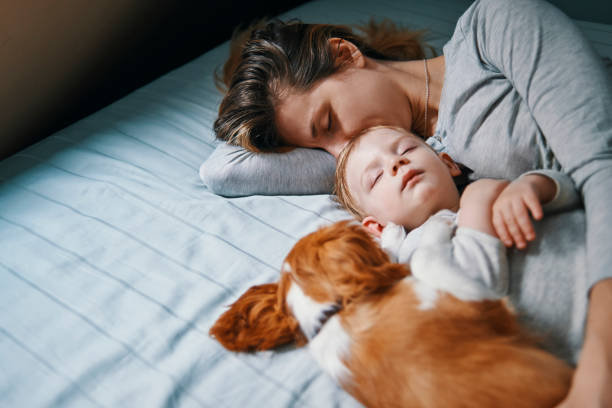 istock young mother taking a nap with her babies 937290482
