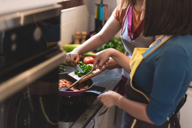 istock Two women making meal together 937290592
