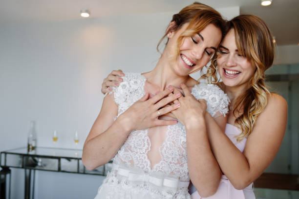 istock Bridesmaid giving a tender hug to beautiful bride 937291316