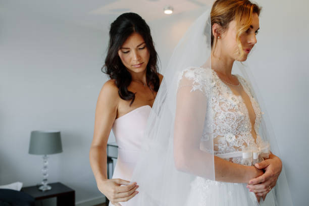 istock Bridesmaid helping bride to put on a veil 937291690