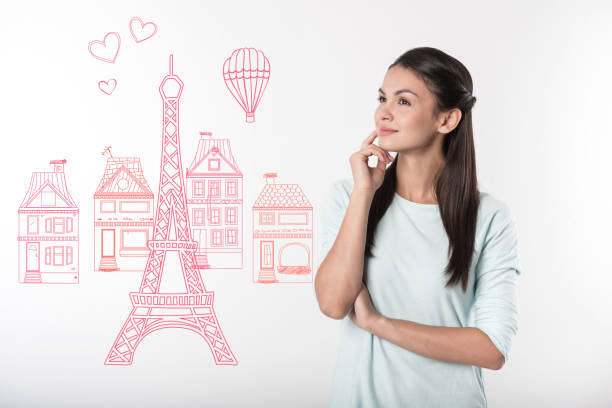 Thoughtful woman touching her chin while dreaming about France
