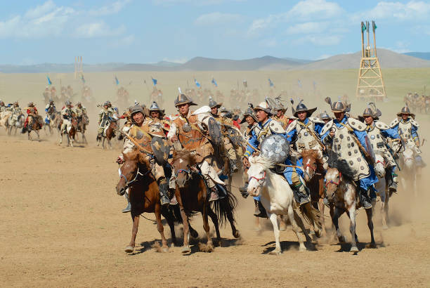 Mongolian horse riders take part in the traditional historical show of Genghis Khan era in Ulaanbaatar, Mongolia. Ulaanbaatar, Mongolia - August 17, 2006: Unidentified Mongolian horse riders take part in the traditional historical show of Genghis Khan era in Ulaanbaatar, Mongolia. mongolian ethnicity stock pictures, royalty-free photos & images
