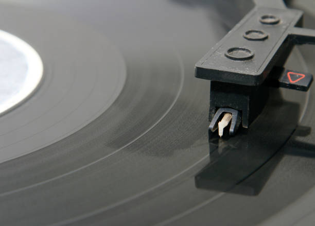 istock turntable with stylus running along a vinyl record 937295504