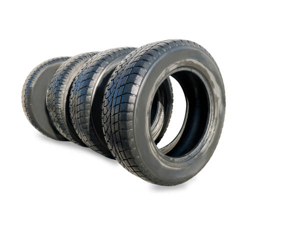 istock Stack of four wheel new black winter tyres for car 937295508