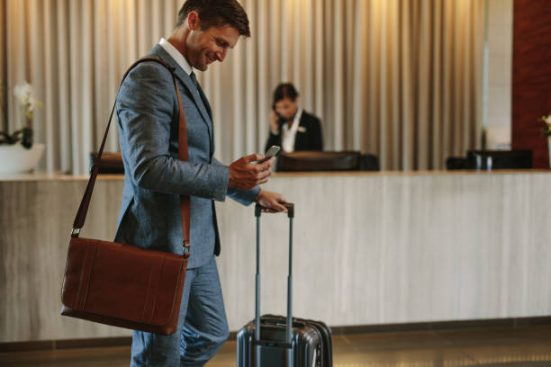 istock Businessman arriving at hotel lobby 937302718