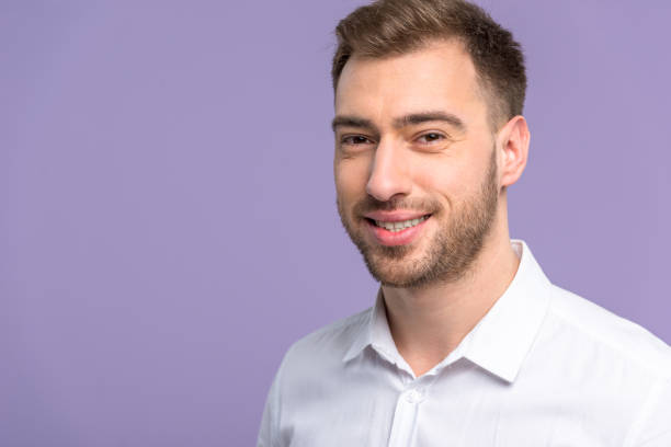 istock Smiling young man isolated on violet 937303106