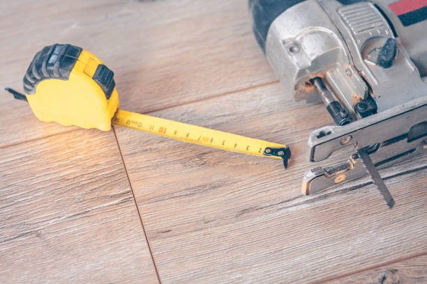 istock Tools carpentry on the floor, jigsaw and construction measuring tape 937306316