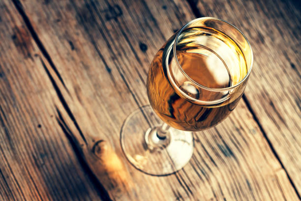 istock wine, white, table, wooden, glass, rustic, background, alcohol, wood, winery, 937311290