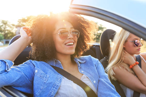 istock Girlfriends having fun on road trip 937323418