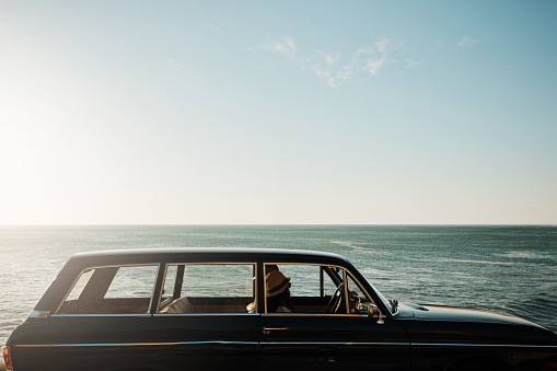 Shot of a young woman going on a road trip along the coast