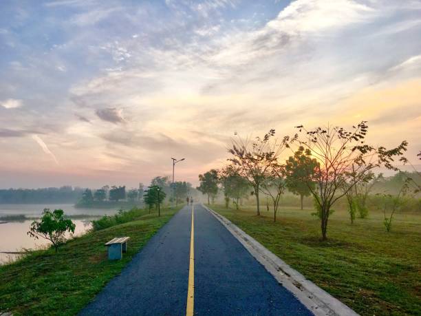 istock Road By Trees Against Sky During Sunset 937327914