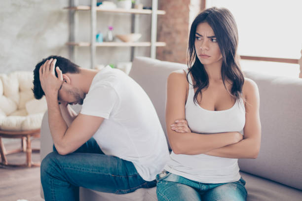 istock Mistrust and cheat problems. Annoyed couple is ignoring each other, sitting on the couch upset indoors at home. I am not talking to you! 937331354