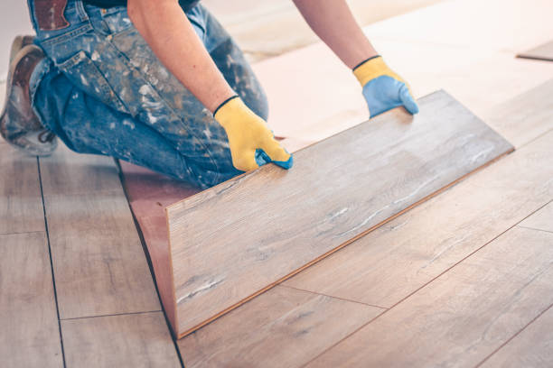 istock Professional installation of floor covering, the worker quickly and qualitatively mounts a laminate board 937331356
