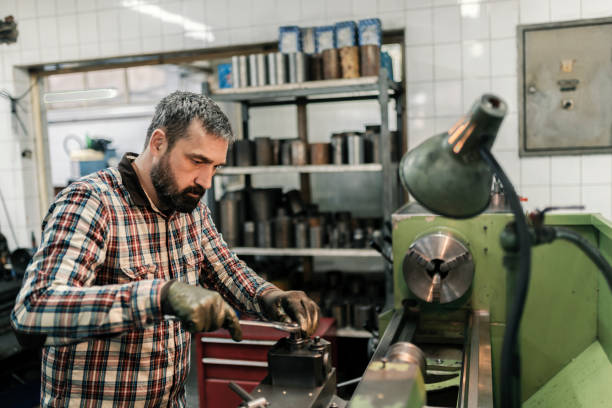 istock Young craftsman working on soldered metal in workshop 937331538