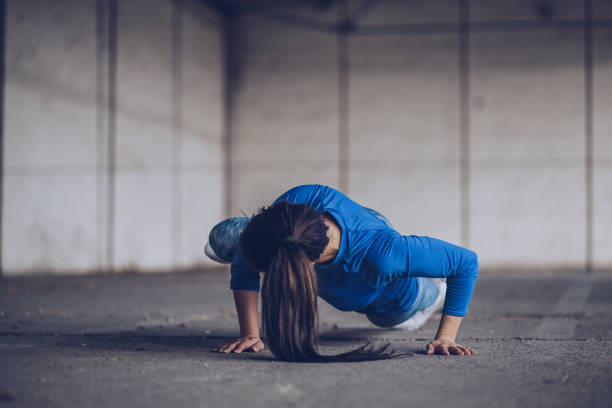 istock Woman doing push-ups in warehouse 937342860