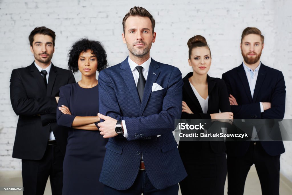 Group of confident, perky lawyers standing together Group of perky lawyers, businesspeople standing together Lawyer Stock Photo