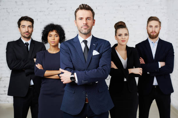 Group of confident, perky lawyers standing together stock photo