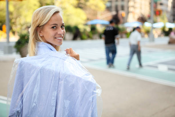 Woman with Laundered Shirt Over Shoulder stock photo