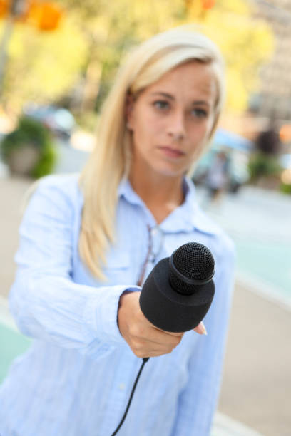 istock Woman Holding Out Microphone 937349780