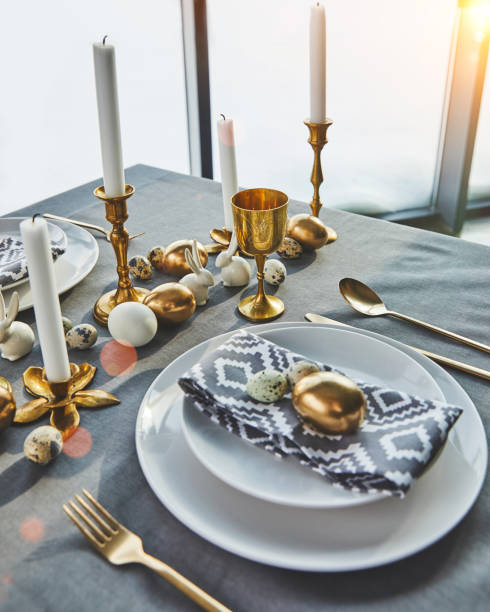 istock festive table with golden eggs and candles, easter concept 937351538