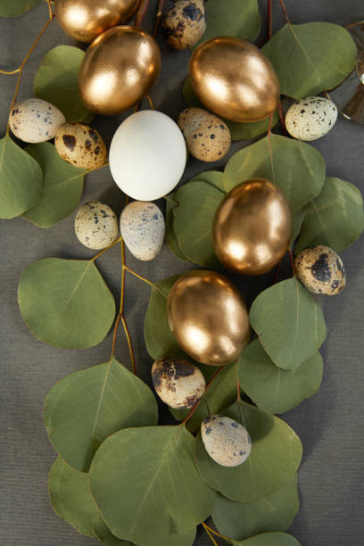istock top view of golden easter eggs on green leaves 937363066