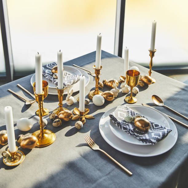 istock high angle view of easter eggs and candles on festive table with sunlight 937363862