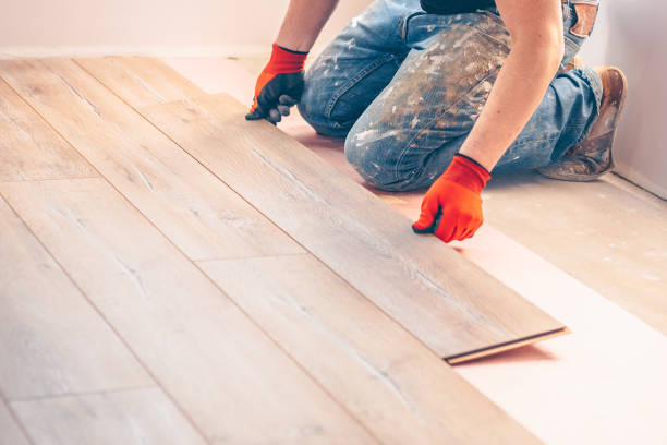 istock Professional installation of floor covering, the worker quickly and qualitatively mounts a laminate board 937364538
