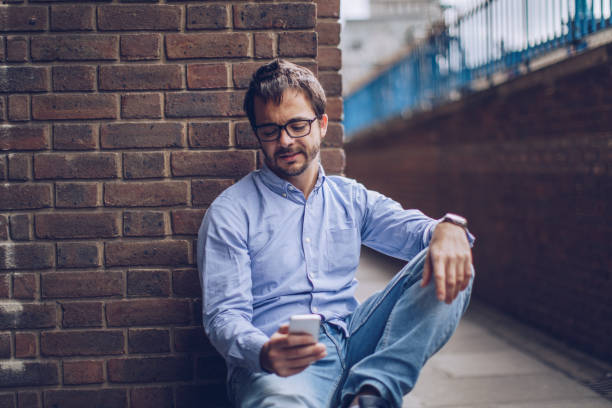 istock Man texting on the phone 937365476