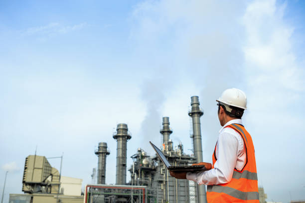 istock Engineering is working in gas turbine electric power plant he check around plant with notebook 937370740