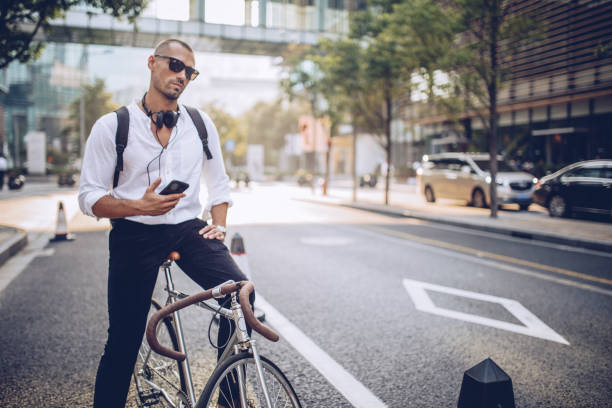 istock Man with headphones and bicycle 937371406