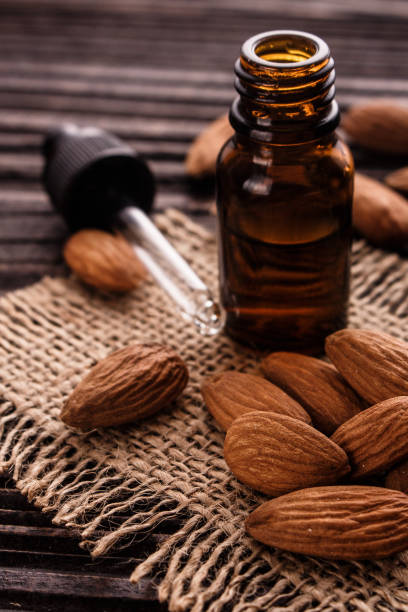 istock almond essential oil on a wooden background 937374102