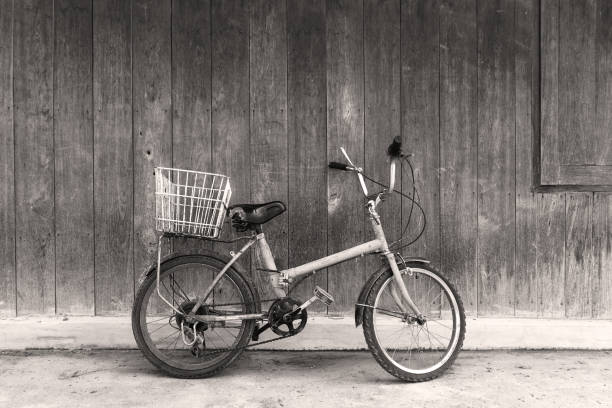 istock Black and white old bicycle leaning against wall 937375610