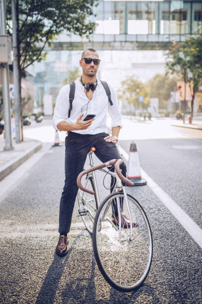 istock Modern man with headphones and bicycle 937375946