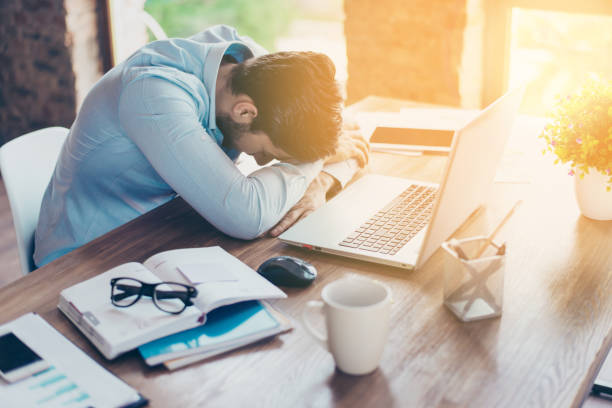 i need a vacation! close up top view portrait of tired sick young brunet guy. he is wearing the formalwear, resting at the workplace - business struggle imagens e fotografias de stock