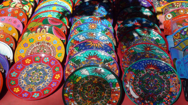 istock Colorful Mexican Souvenir Plates On Display Scene In Mexico 937384432