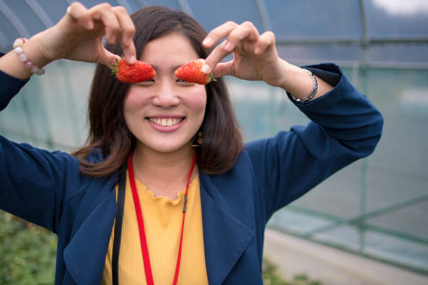 istock Young woman putting strawberries on eyes 937388226